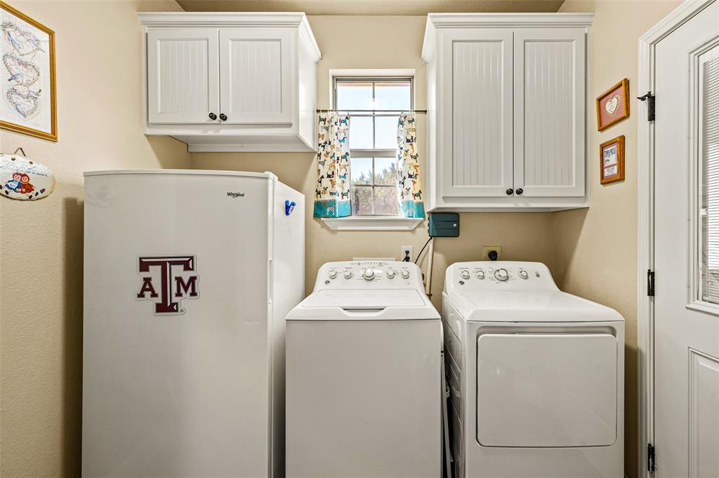 1177 Ronald Road Glen Rose, TX 76043 - Photo 14 of 30 a utility room with dryer and washer