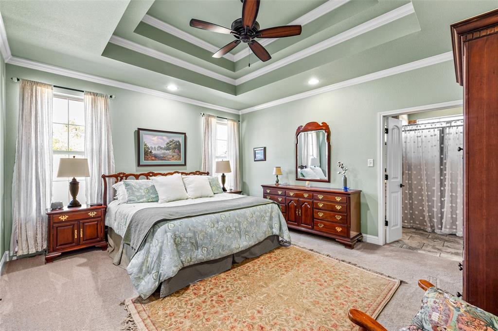 1177 Ronald Road Glen Rose, TX 76043 - Photo 15 of 30 a bedroom with a bed and a chandelier