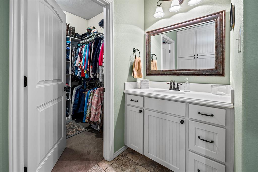 1177 Ronald Road Glen Rose, TX 76043 - Photo 19 of 30 a bathroom with a sink vanity and a mirror