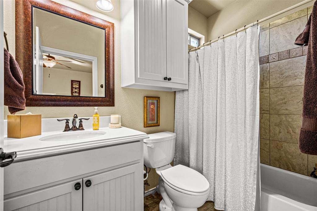 1177 Ronald Road Glen Rose, TX 76043 - Photo 21 of 30 a bathroom with a sink a toilet and shower