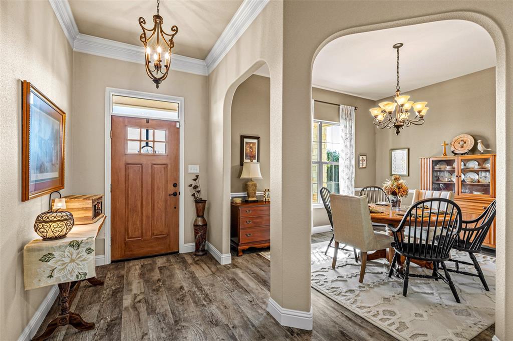 1177 Ronald Road Glen Rose, TX 76043 - Photo 3 of 30 a view of a dining room with furniture and chandelier