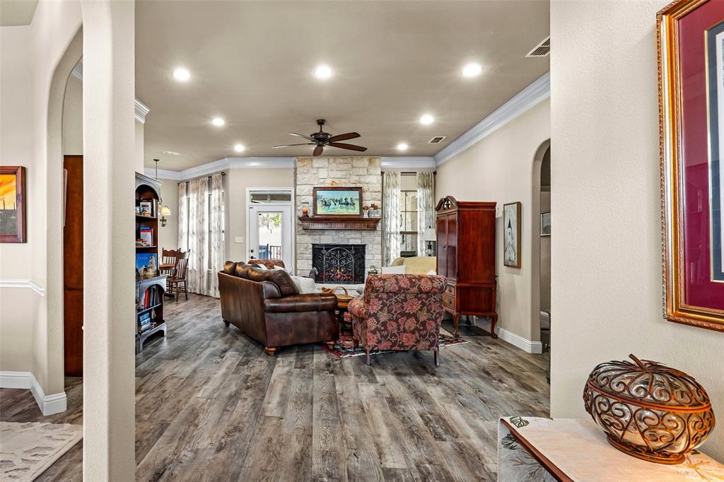 1177 Ronald Road Glen Rose, TX 76043 - Photo 4 of 30 a living room with furniture a fireplace and a flat screen tv