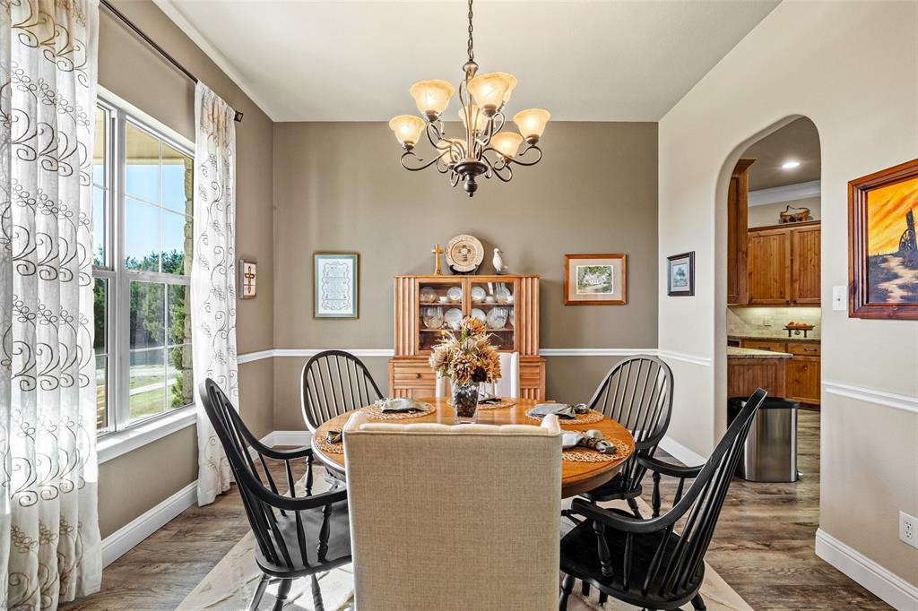 1177 Ronald Road Glen Rose, TX 76043 - Photo 5 of 30 a view of a dining room with furniture wooden floor and chandelier