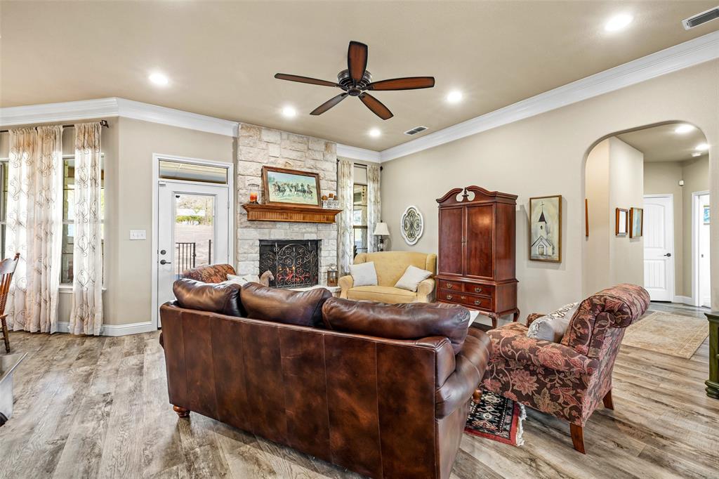 1177 Ronald Road Glen Rose, TX 76043 - Photo 6 of 30 a living room with furniture a fireplace and a flat screen tv