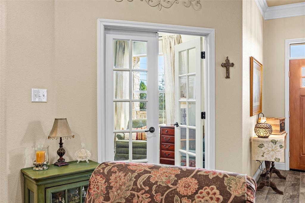 1177 Ronald Road Glen Rose, TX 76043 - Photo 8 of 30 a bedroom with a bed and a table in it