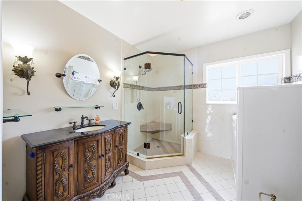 6481 Dos Rios Road Downey, CA 90240 - Photo 9 of 27 a bathroom with a double vanity sink mirror toilet and shower