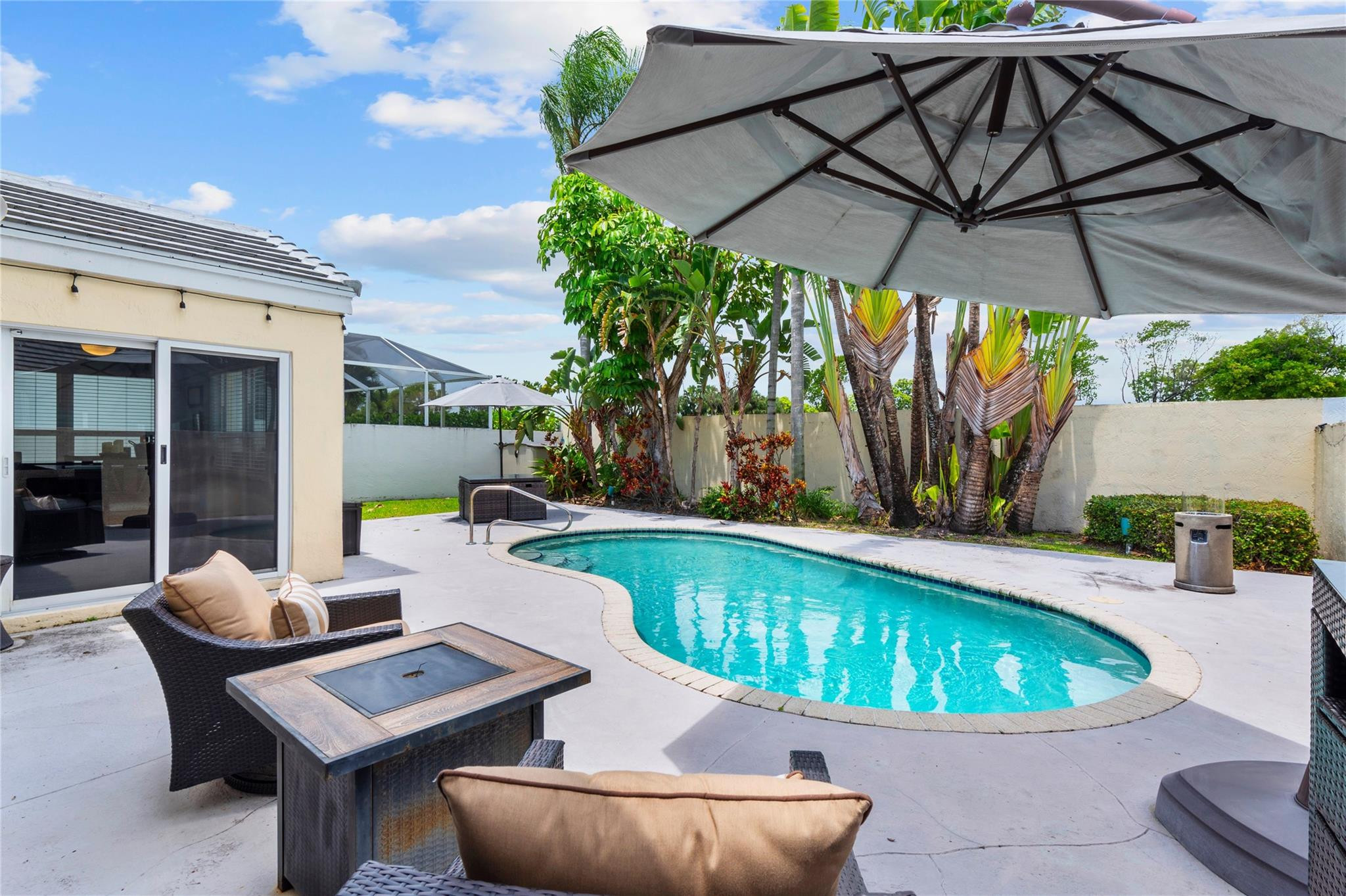 7904 Travelers Tree Drive Boca Raton, FL 33433 - Photo 12 of 35 a view of a swimming pool with a patio
