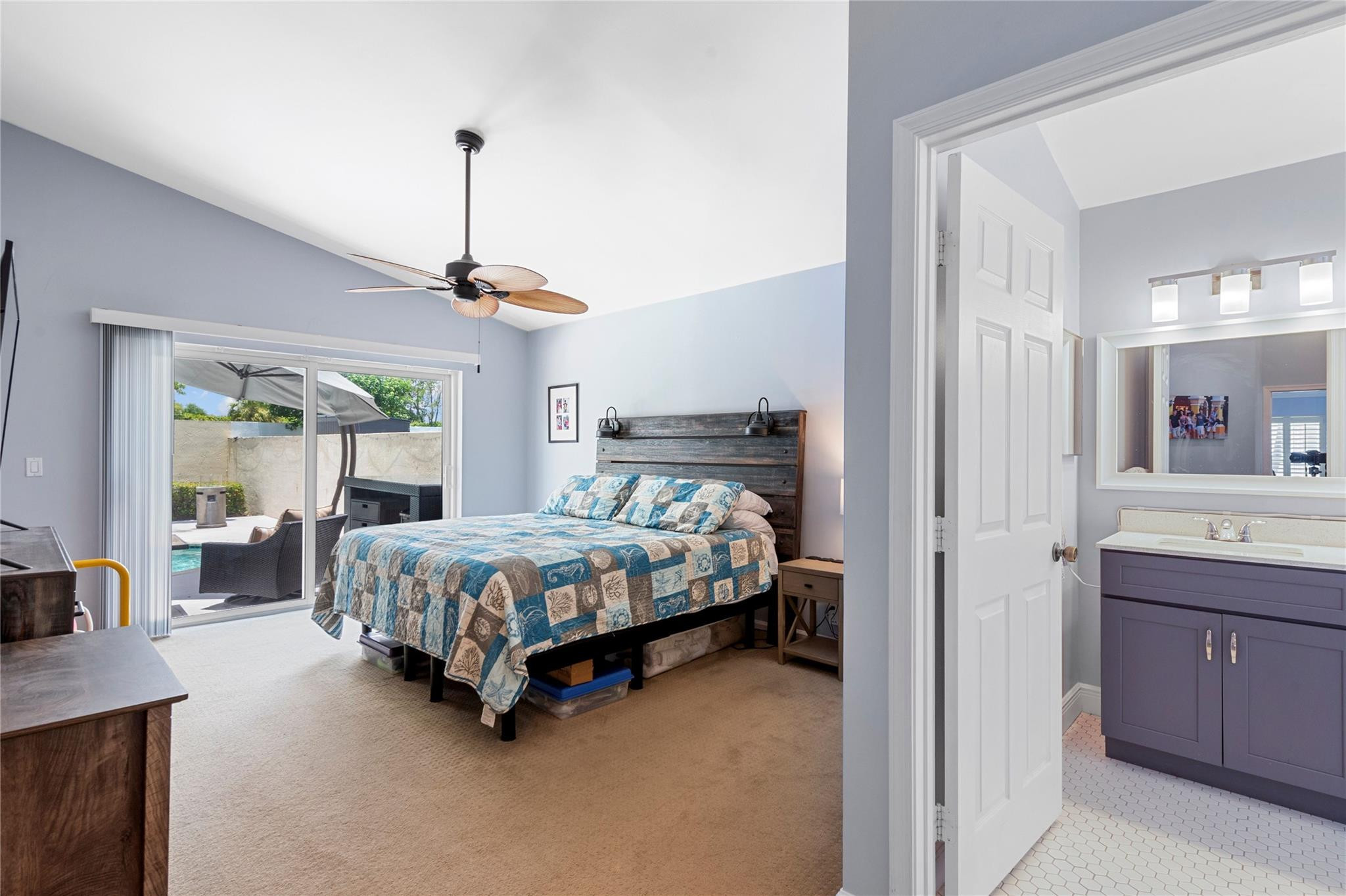 7904 Travelers Tree Drive Boca Raton, FL 33433 - Photo 18 of 35 a bed room with a bed and a chandelier
