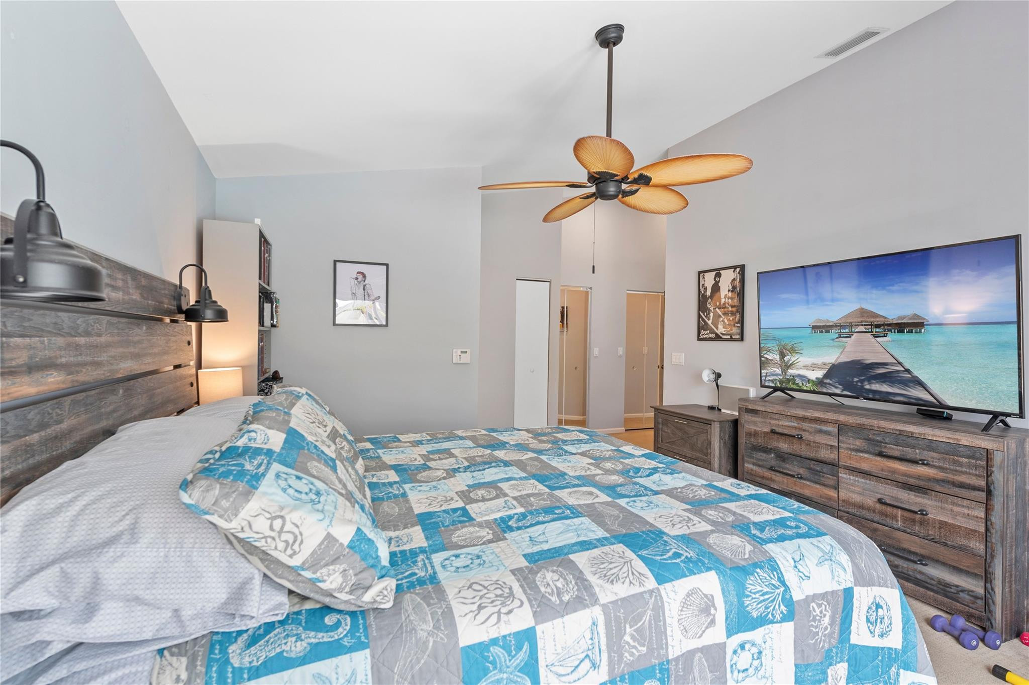 7904 Travelers Tree Drive Boca Raton, FL 33433 - Photo 19 of 35 a bedroom with a bed and a chandelier