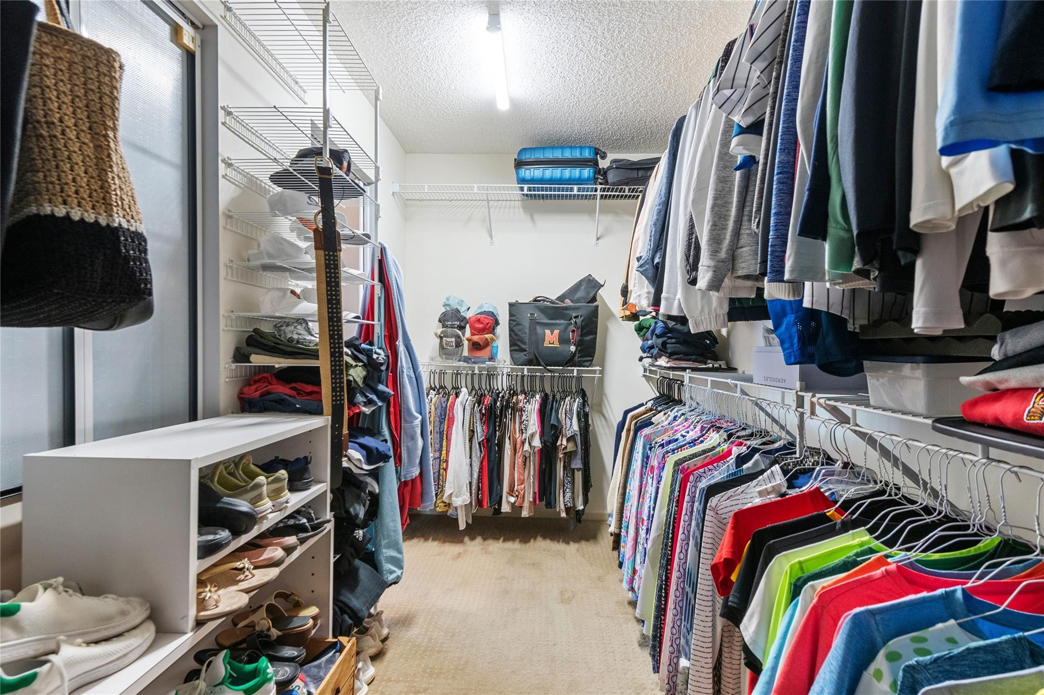 7904 Travelers Tree Drive Boca Raton, FL 33433 - Photo 23 of 35 a view of walk in closet with clothes and shoes