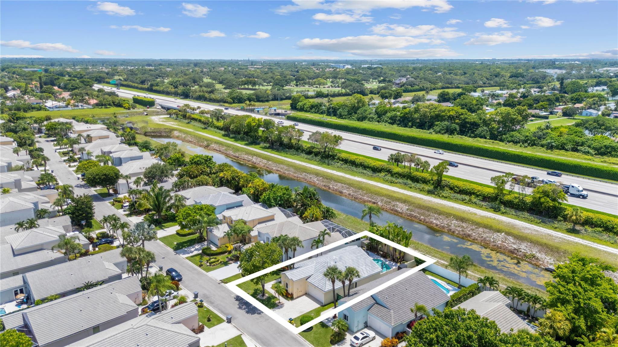 7904 Travelers Tree Drive Boca Raton, FL 33433 - Photo 31 of 35 an aerial view of a city with lots of residential buildings ocean and mountain view in back