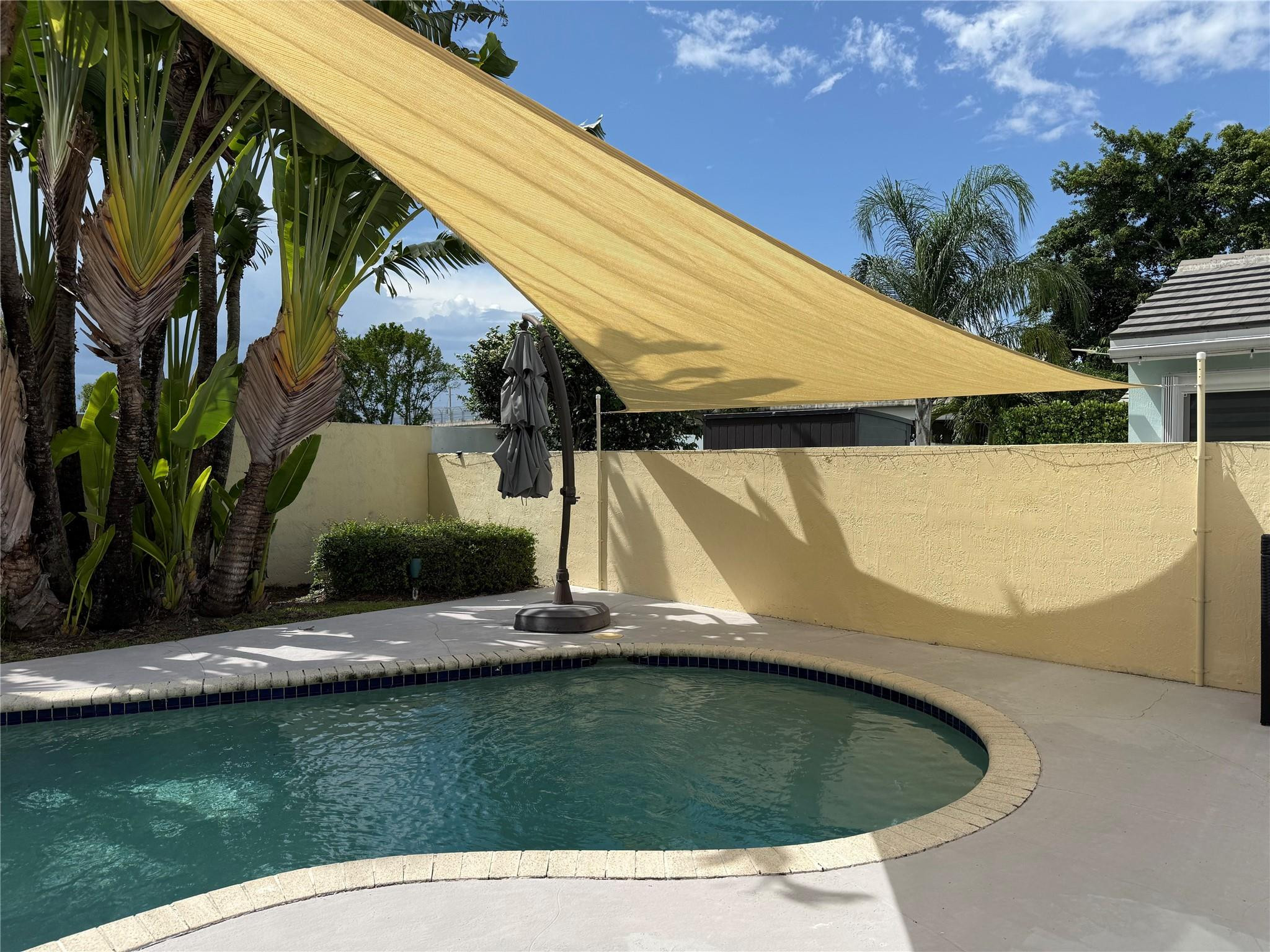 7904 Travelers Tree Drive Boca Raton, FL 33433 - Photo 33 of 35 a view of a swimming pool with a yard