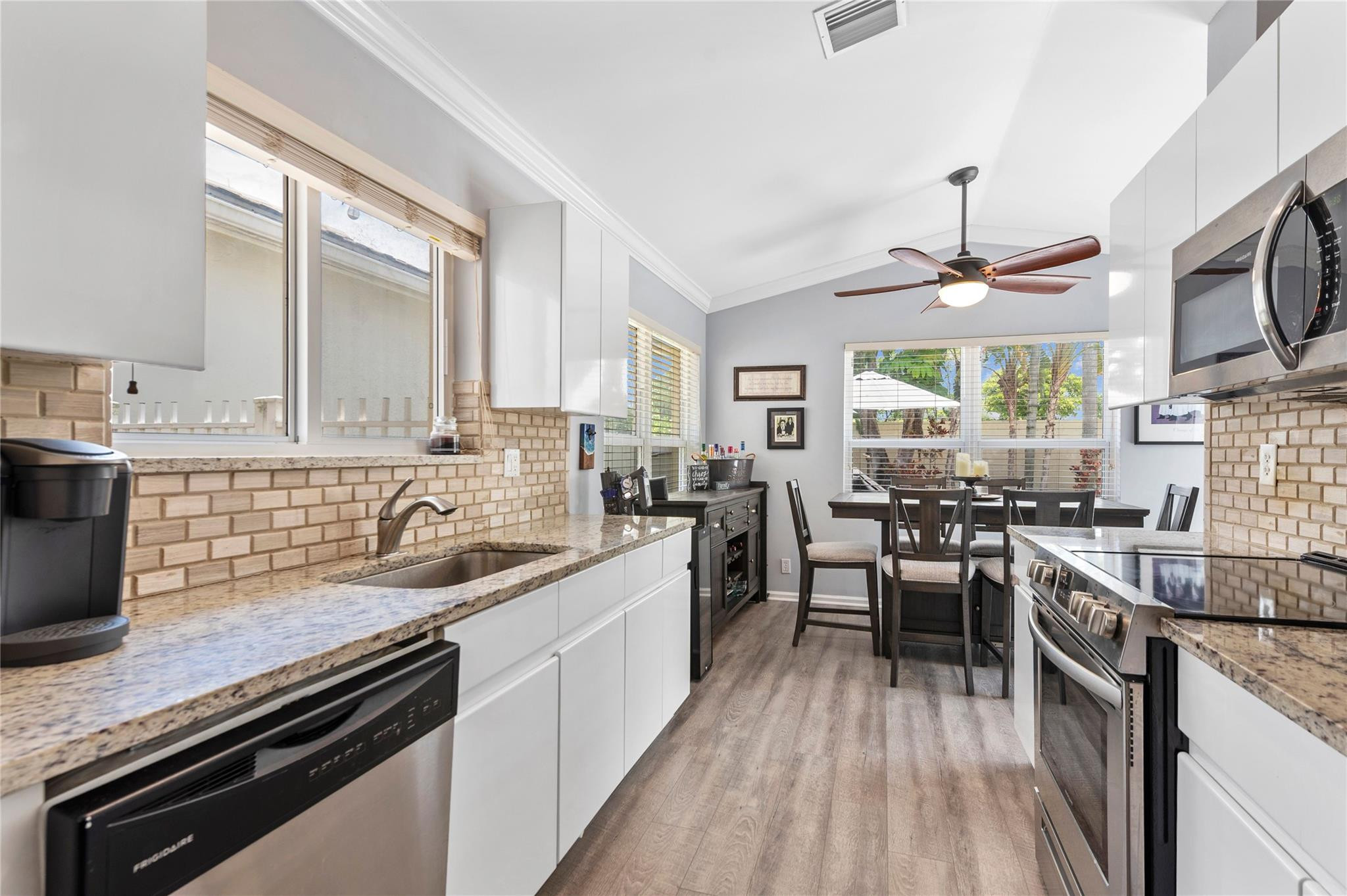 7904 Travelers Tree Drive Boca Raton, FL 33433 - Photo 9 of 35 a kitchen with sink stove and cabinets