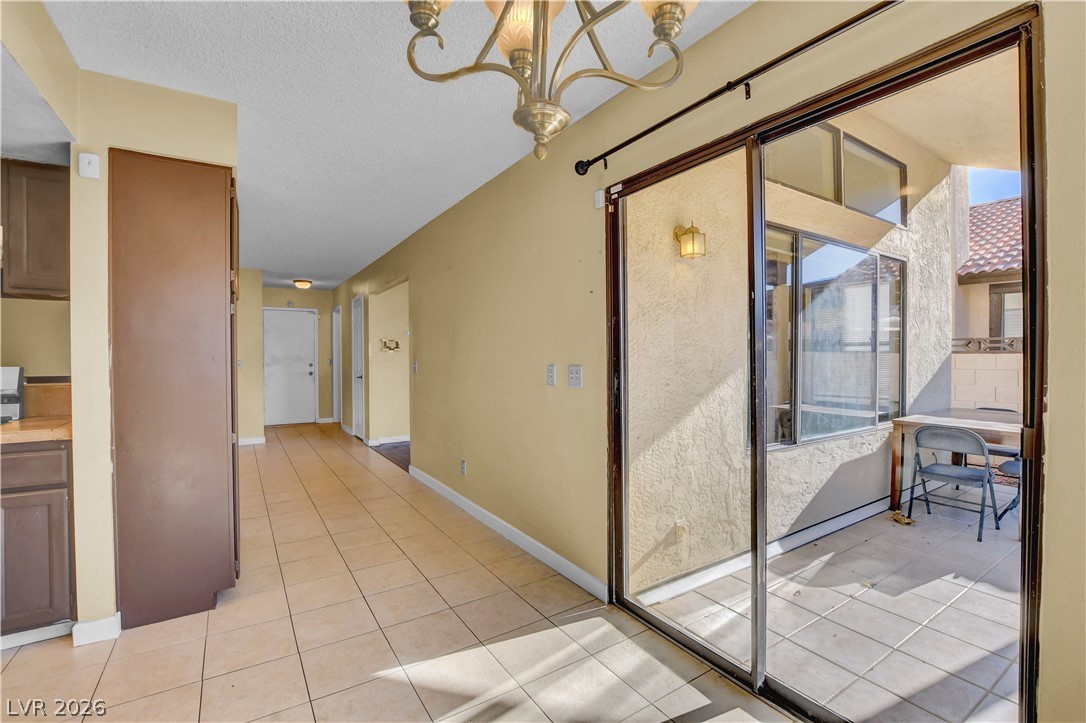 6440 Hartwood Road Las Vegas, NV 89108 - Photo 16 of 59 Step into a luminous interior featuring tile flooring and convenient sliding doors opening to a private patio.