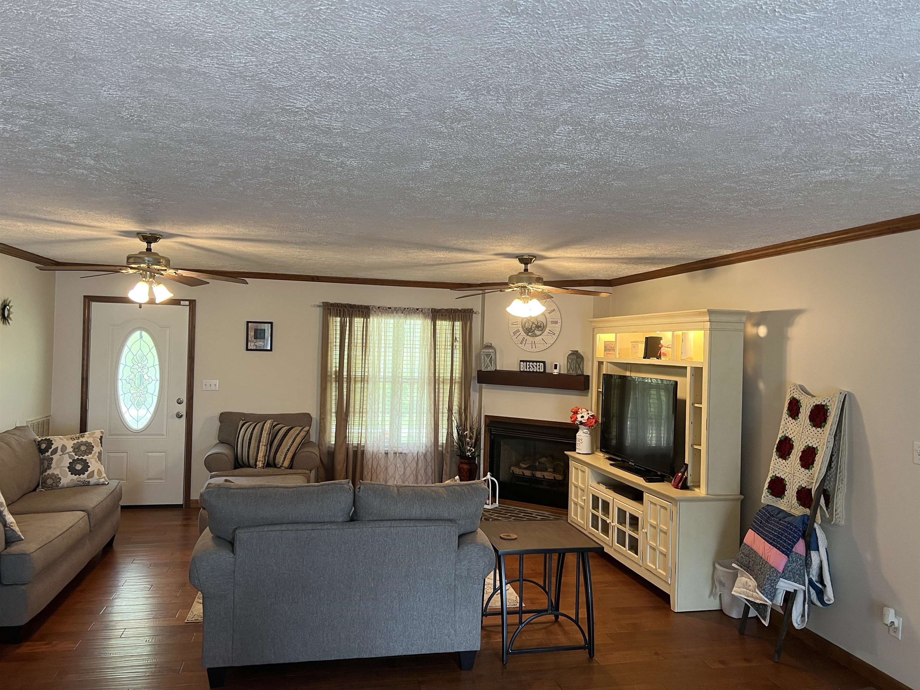 860 Plainview Road Henderson, TN 38340 - Photo 11 of 40 a living room with furniture a fireplace and a flat screen tv