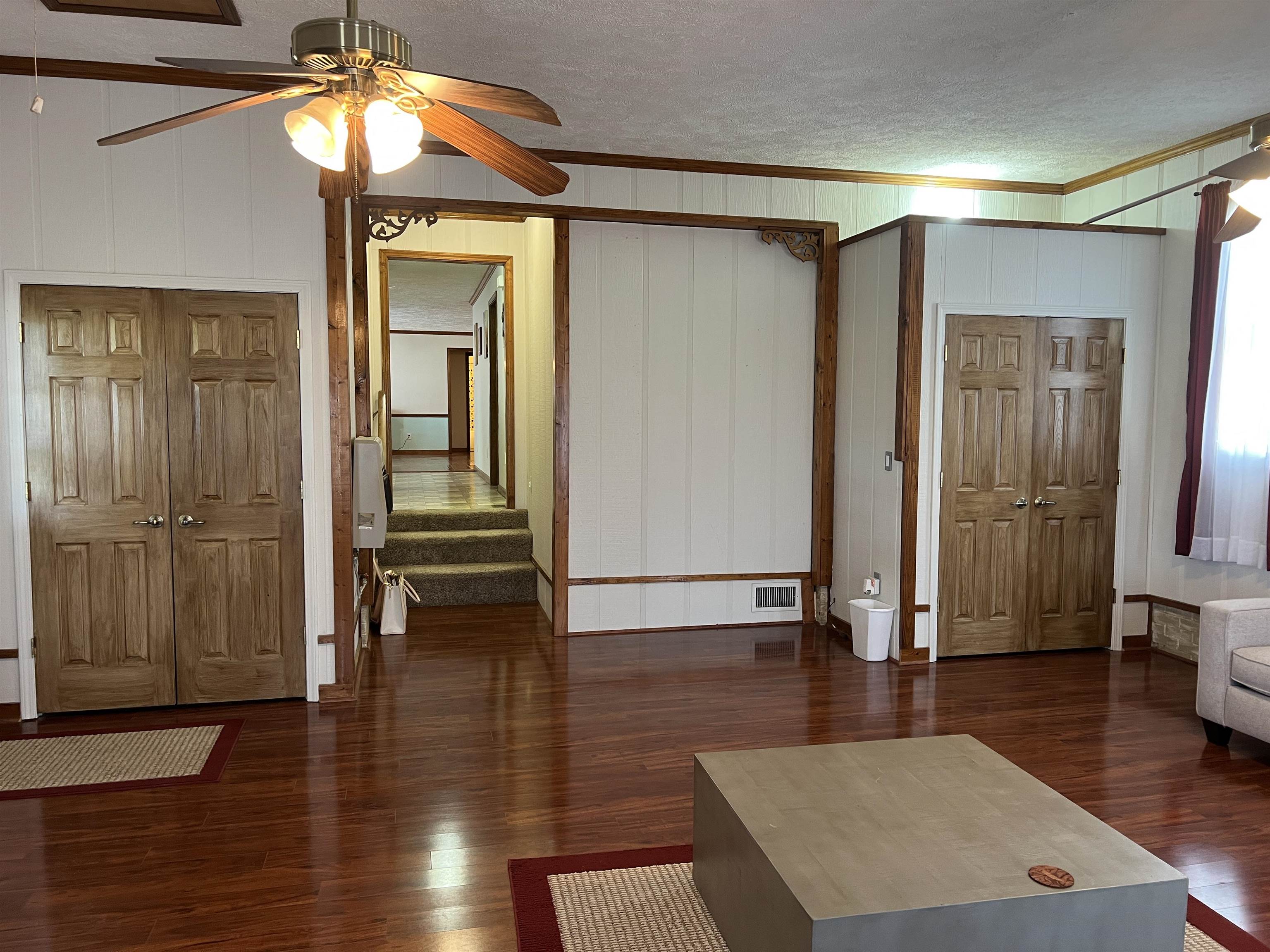860 Plainview Road Henderson, TN 38340 - Photo 7 of 40 a view of a hallway with wooden floor and a chandelier