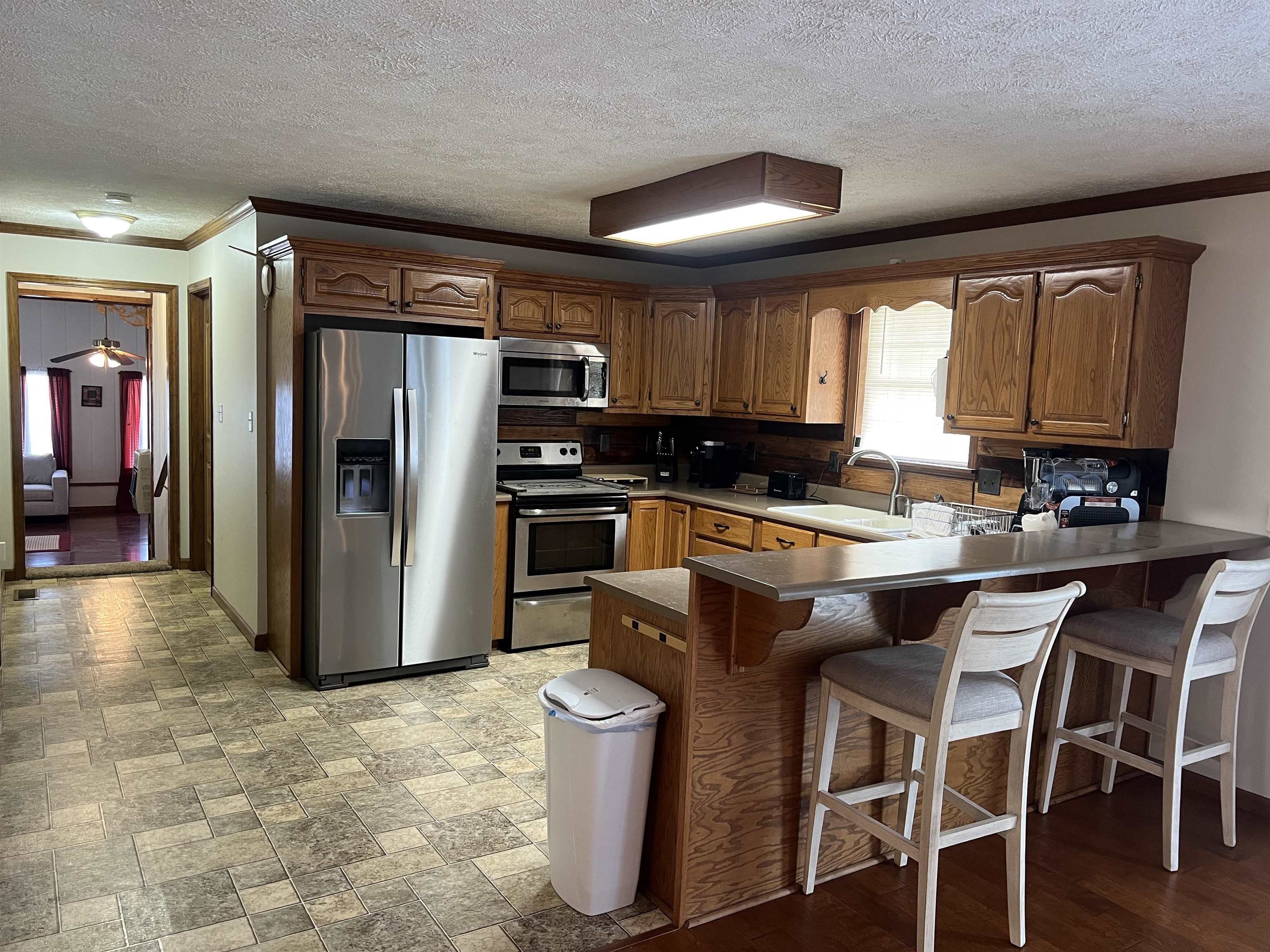860 Plainview Road Henderson, TN 38340 - Photo 8 of 40 a kitchen with a refrigerator and a stove top oven
