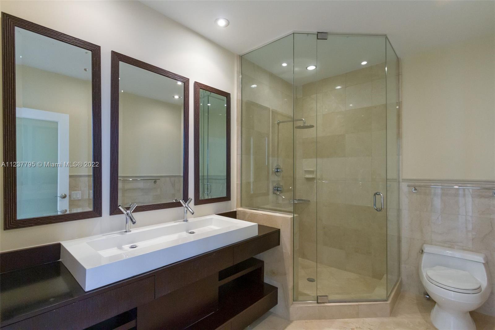 888 Brickell Key Drive, Unit PH2802 Miami, FL 33131 - Photo 15 of 47 a bathroom with a sink shower and a mirror