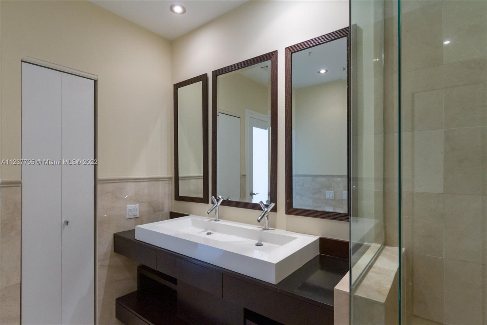 888 Brickell Key Drive, Unit PH2802 Miami, FL 33131 - Photo 16 of 47 a bathroom with a sink and a mirror