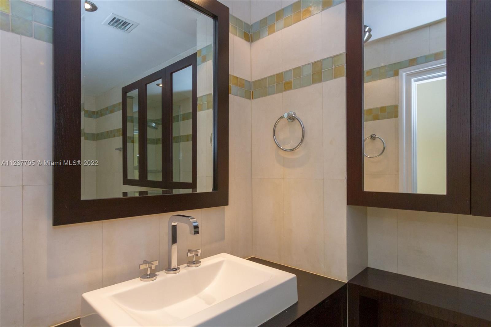 888 Brickell Key Drive, Unit PH2802 Miami, FL 33131 - Photo 17 of 47 a bathroom with a sink and a mirror