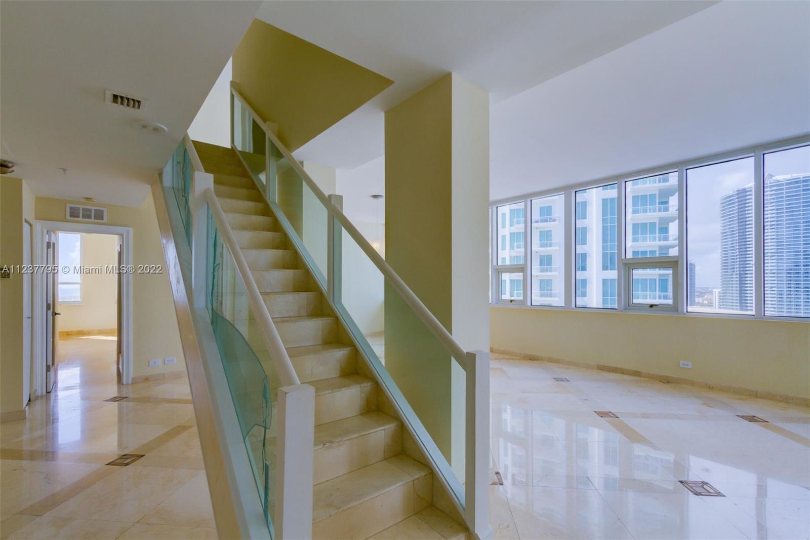 888 Brickell Key Drive, Unit PH2802 Miami, FL 33131 - Photo 2 of 47 a view of entryway and hall with wooden floor