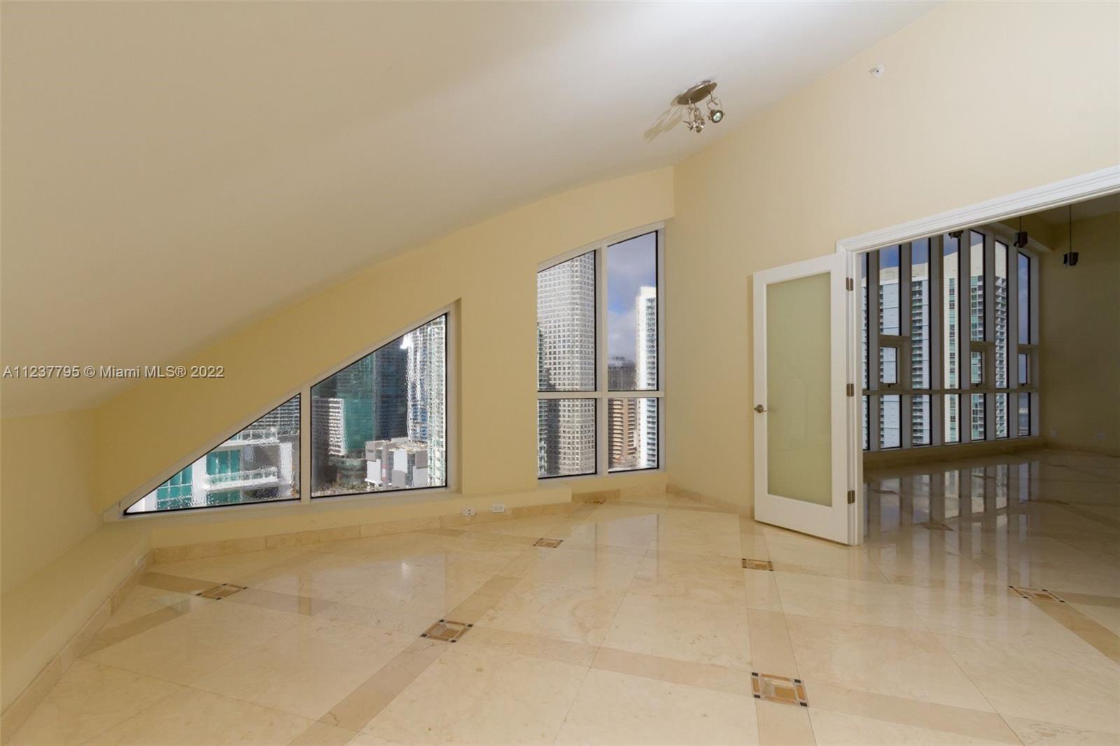 888 Brickell Key Drive, Unit PH2802 Miami, FL 33131 - Photo 23 of 47 a view of an entryway with wooden floor