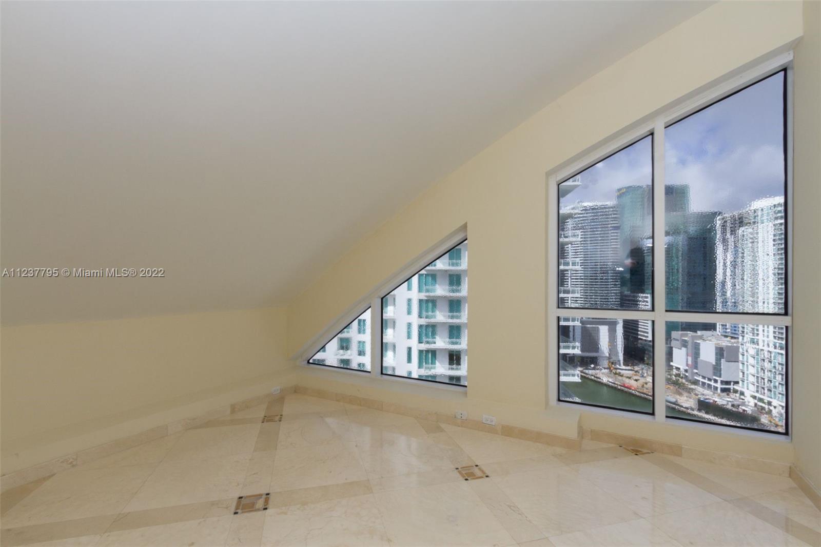 888 Brickell Key Drive, Unit PH2802 Miami, FL 33131 - Photo 24 of 47 a view of an empty room and window