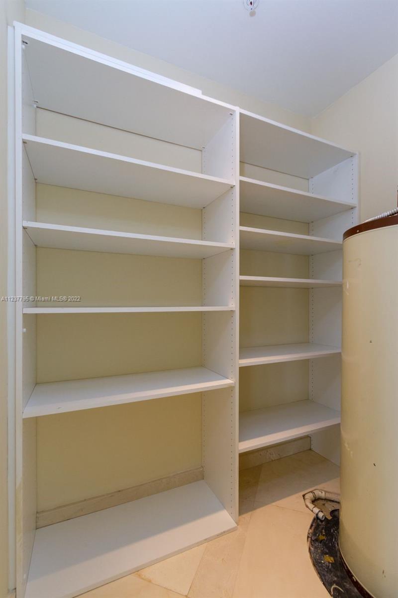 888 Brickell Key Drive, Unit PH2802 Miami, FL 33131 - Photo 25 of 47 a view of walk in closet with empty racks