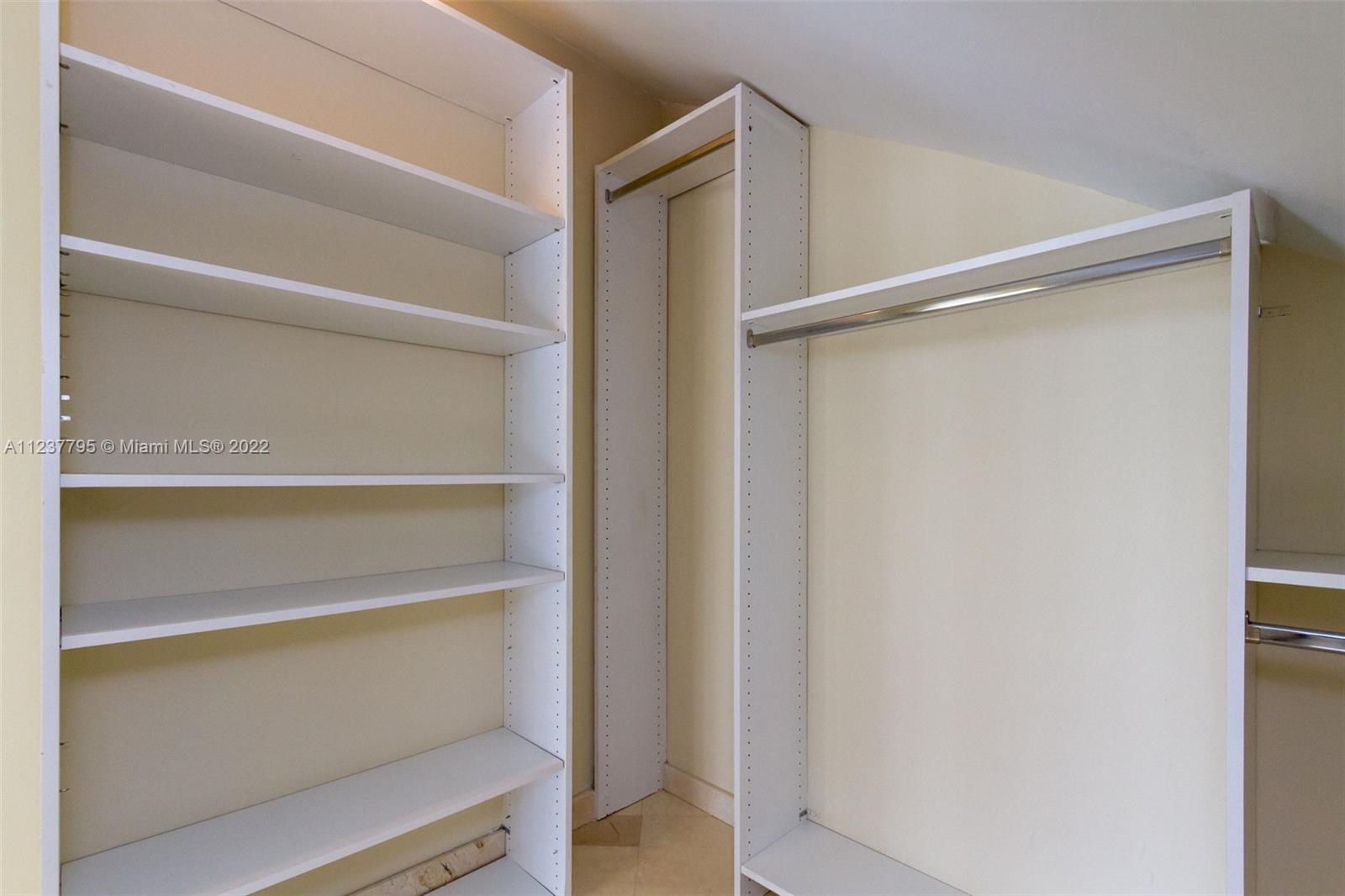 888 Brickell Key Drive, Unit PH2802 Miami, FL 33131 - Photo 26 of 47 a view of walk in closet with empty racks