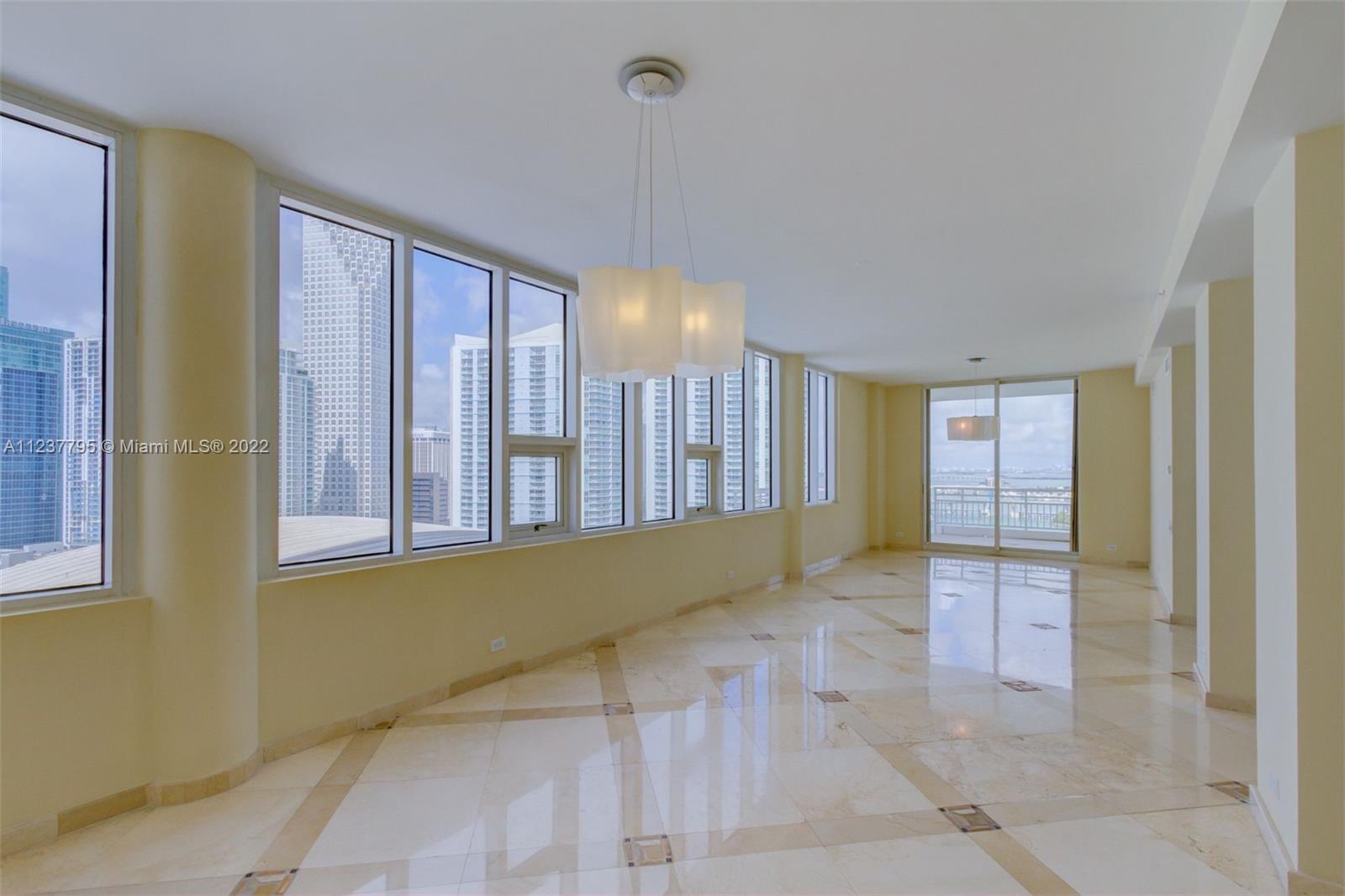 888 Brickell Key Drive, Unit PH2802 Miami, FL 33131 - Photo 3 of 47 a view of a livingroom with an empty space and a window