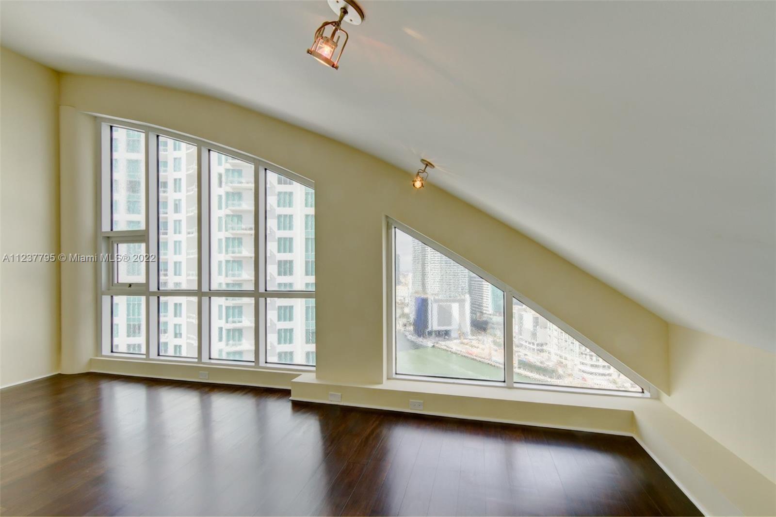 888 Brickell Key Drive, Unit PH2802 Miami, FL 33131 - Photo 34 of 47 a view of an empty room with wooden floor and walls