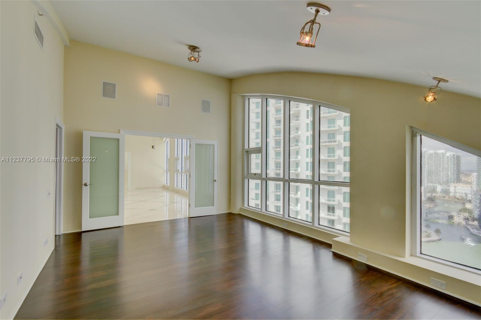 888 Brickell Key Drive, Unit PH2802 Miami, FL 33131 - Photo 35 of 47 wooden floor in an empty room with a window