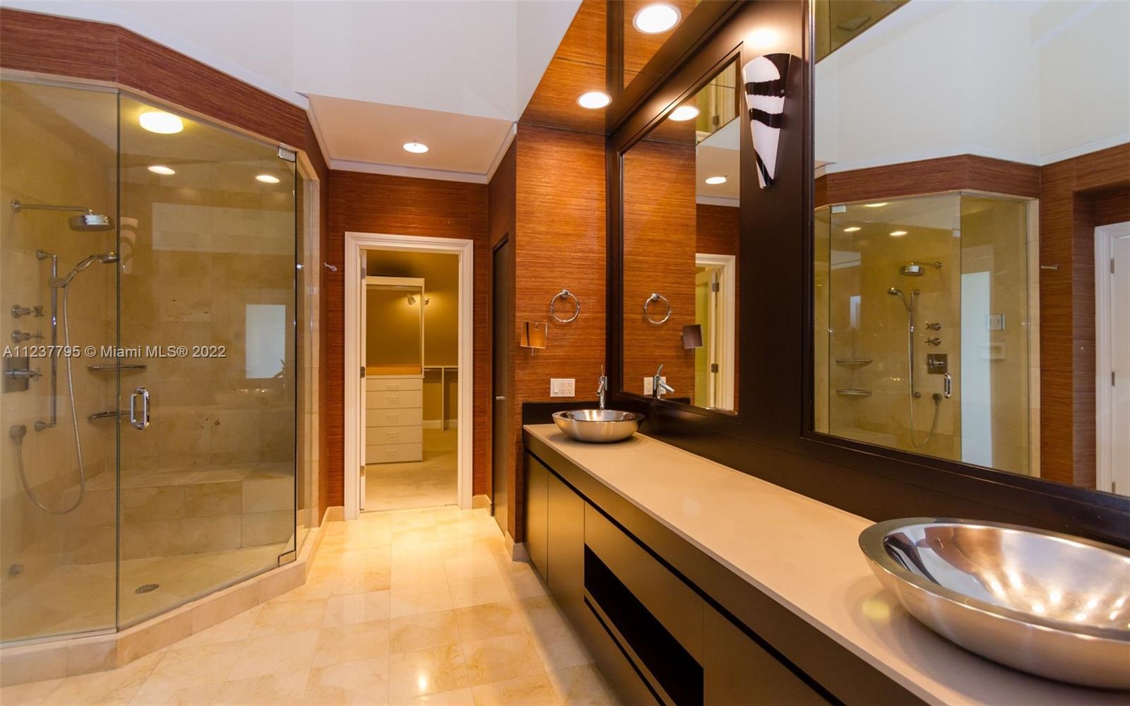 888 Brickell Key Drive, Unit PH2802 Miami, FL 33131 - Photo 37 of 47 a bathroom with a double vanity sink and a mirror