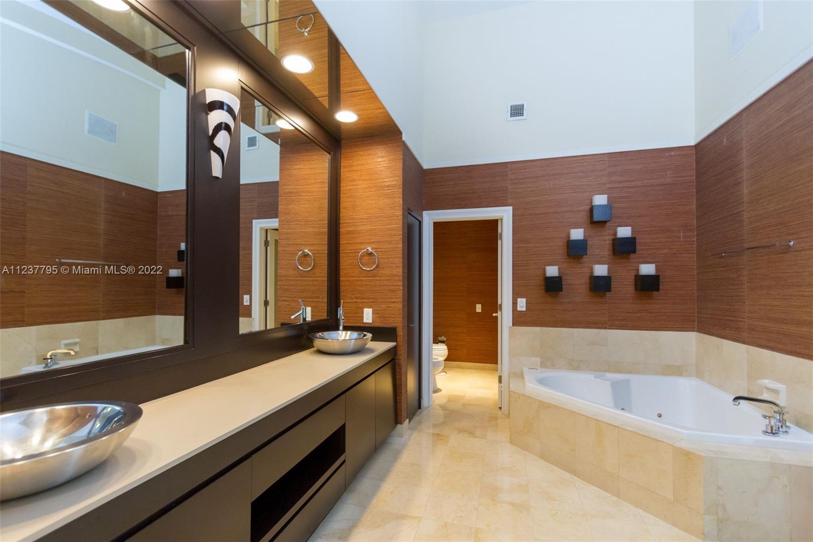 888 Brickell Key Drive, Unit PH2802 Miami, FL 33131 - Photo 38 of 47 a spacious bathroom with a bathtub and double vanity