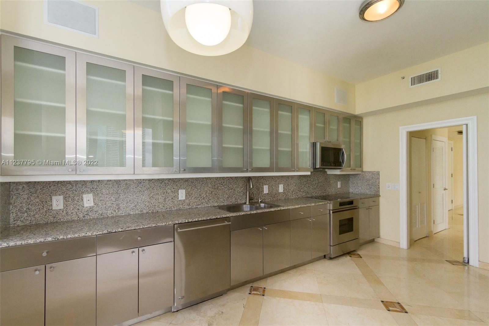 888 Brickell Key Drive, Unit PH2802 Miami, FL 33131 - Photo 10 of 47 a kitchen with stainless steel appliances granite countertop a sink and a stove
