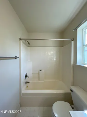 a bathroom with a shower and a toilet