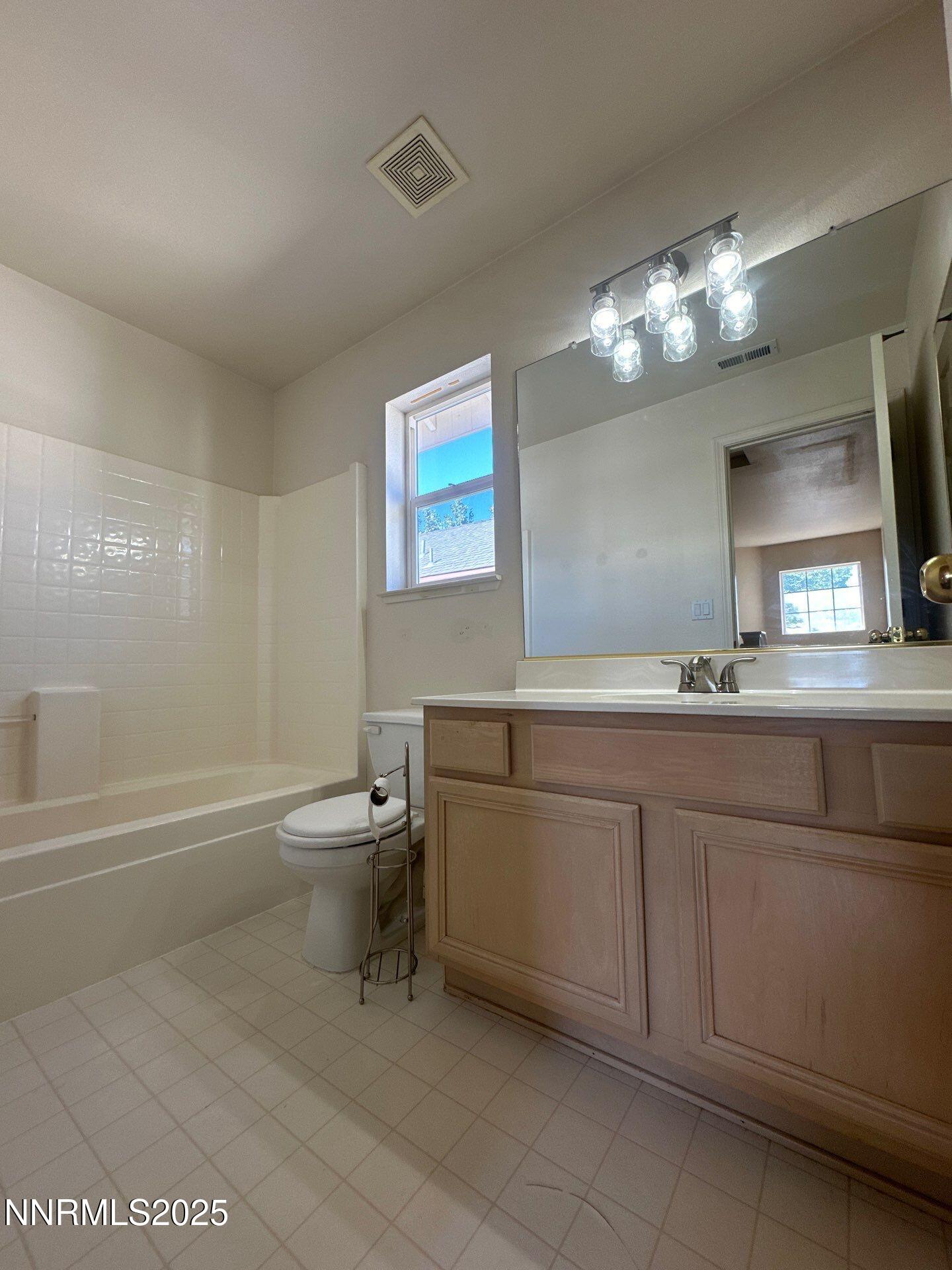 2159 Golden Eagle Court Reno, NV 89523 - Photo 14 of 18 a bathroom with a sink a toilet and a bathtub