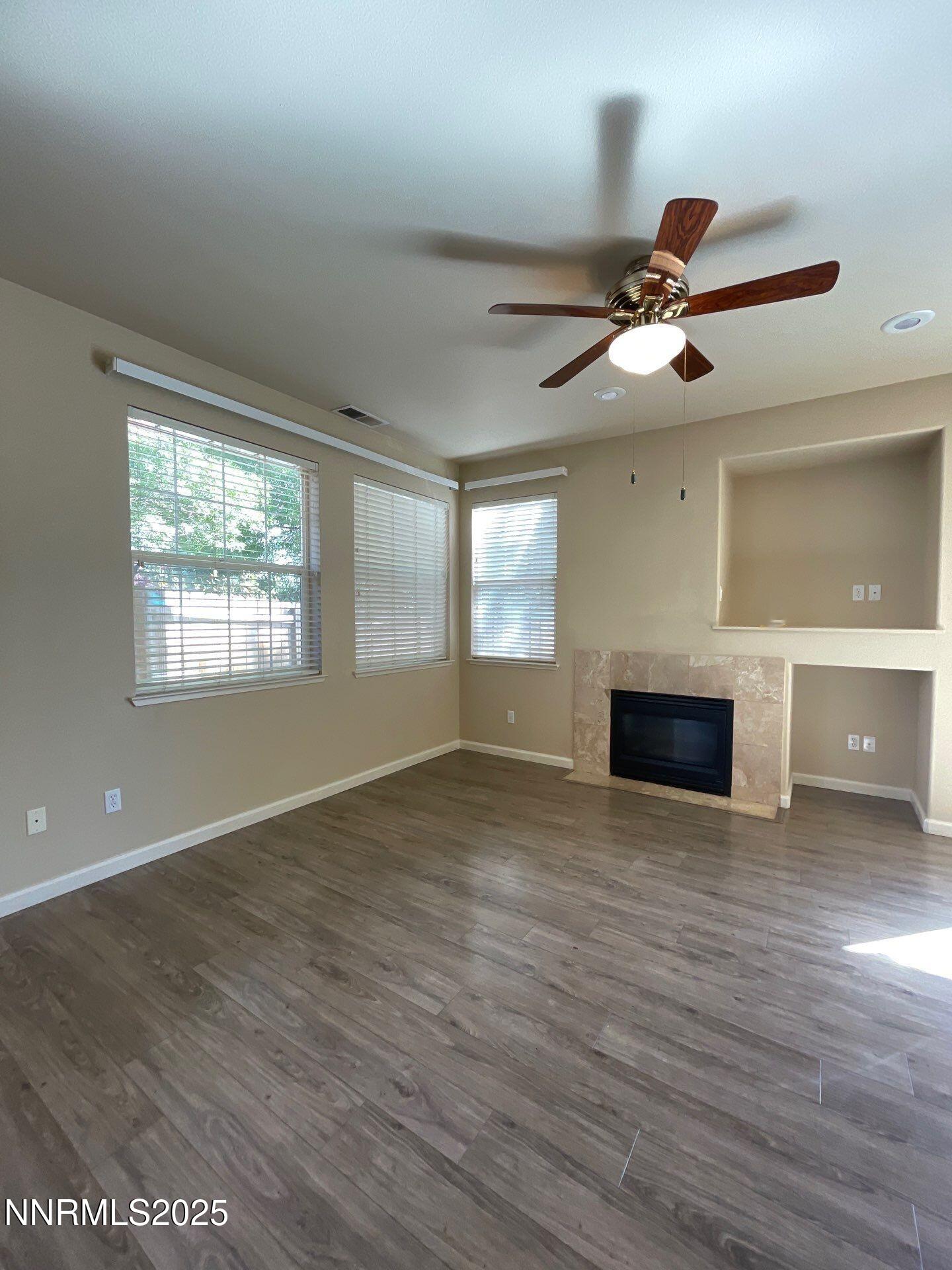 2159 Golden Eagle Court Reno, NV 89523 - Photo 3 of 18 a view of empty room with wooden floor and fan