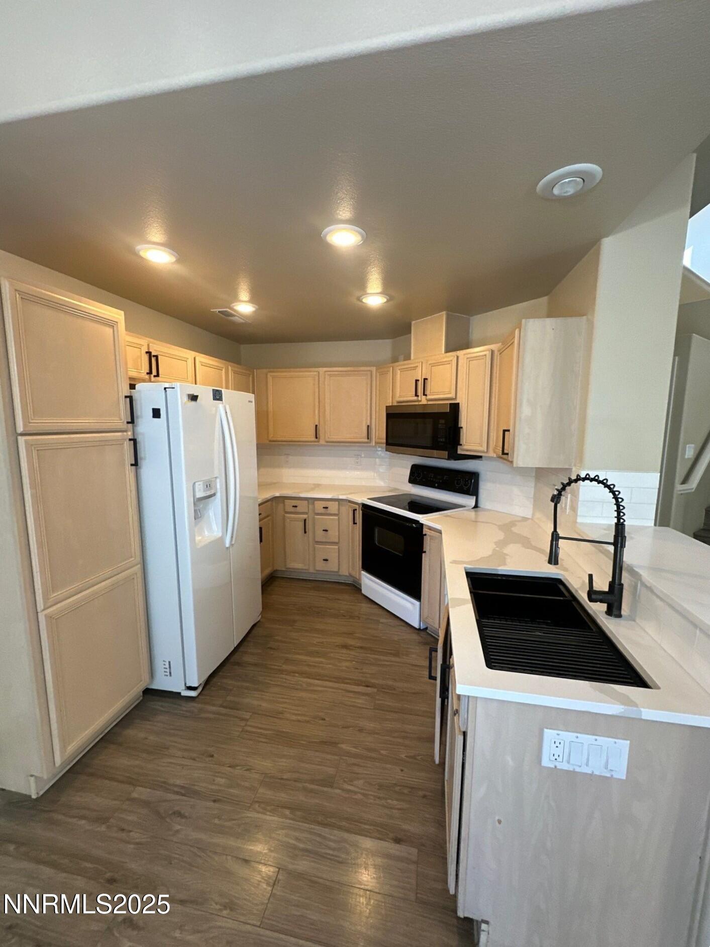 2159 Golden Eagle Court Reno, NV 89523 - Photo 4 of 18 a kitchen with granite countertop a refrigerator stove and sink