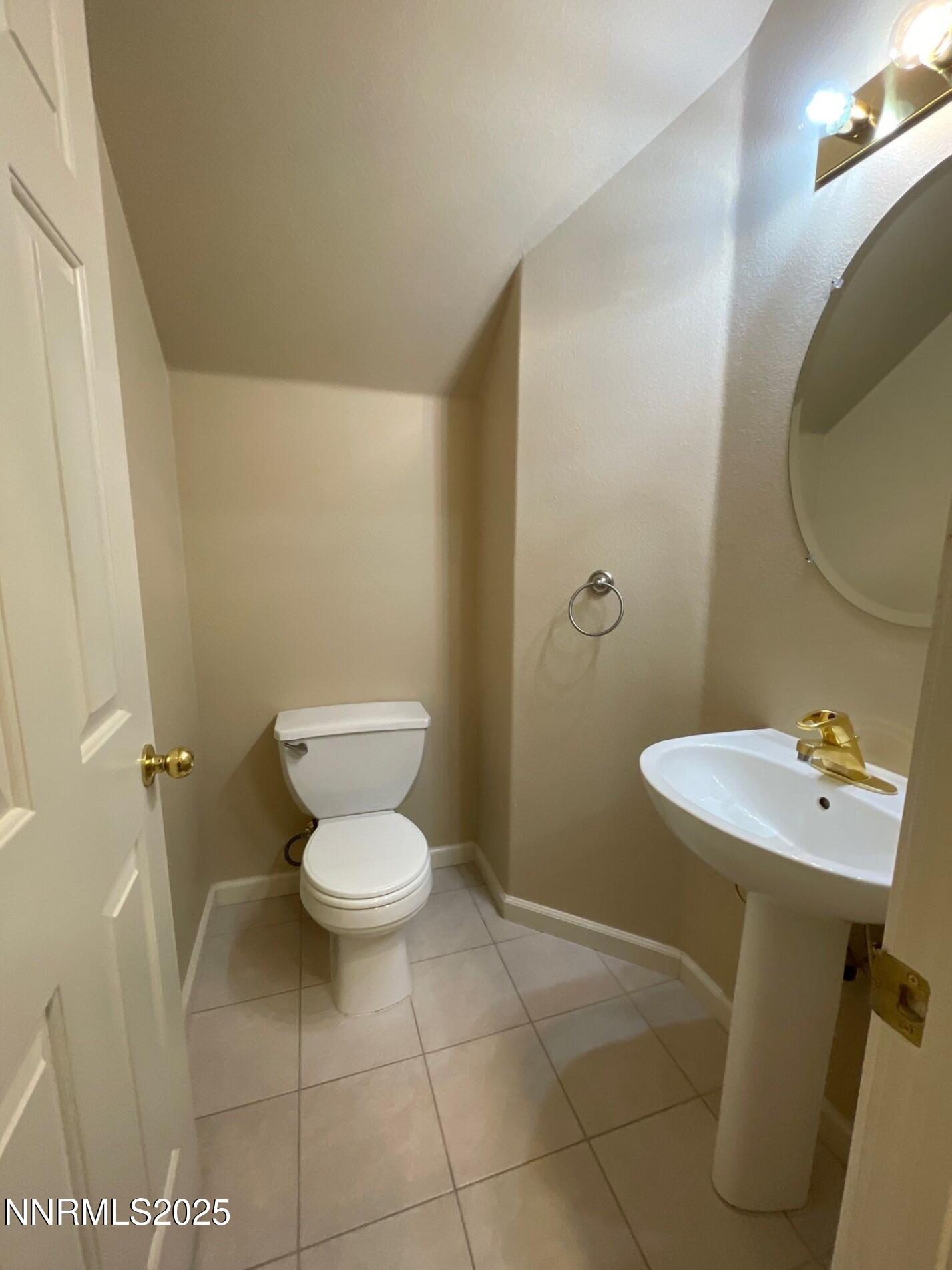 2159 Golden Eagle Court Reno, NV 89523 - Photo 5 of 18 a bathroom with a toilet sink and mirror