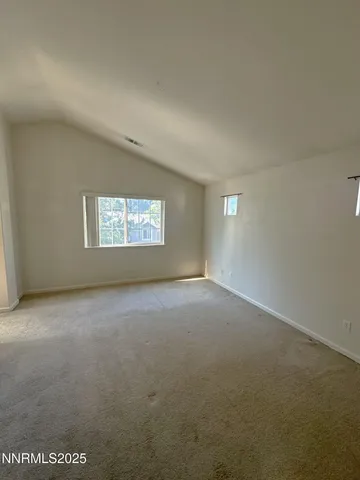 a view of a big room with windows and chandelier fan