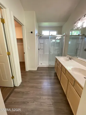 a bathroom with a sink a mirror and a shower