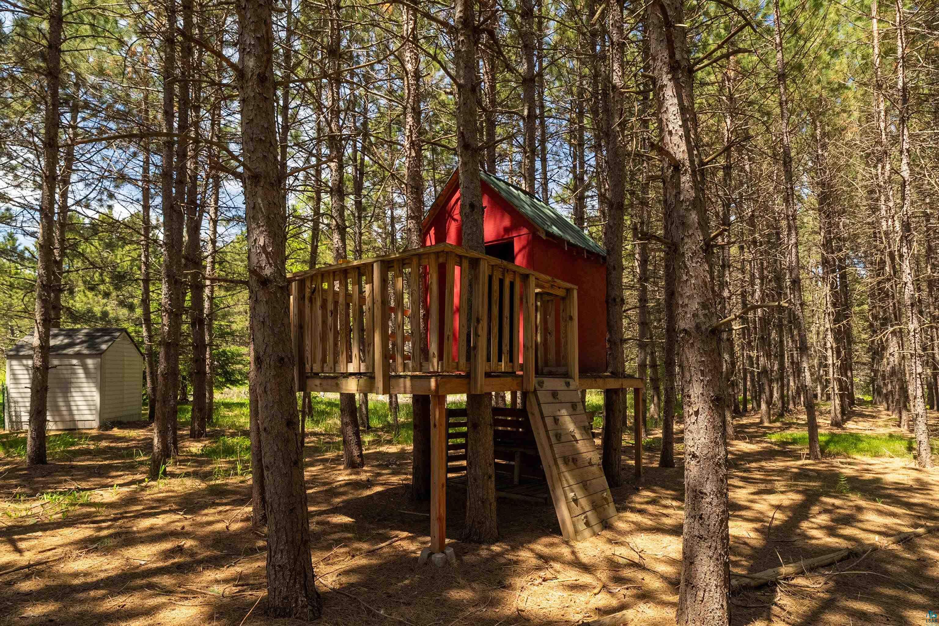 75 East Stark Road Esko, MN 55733 - Photo 67 of 87 Elevated red playhouse featuring a natural wood deck and integrated ladder access