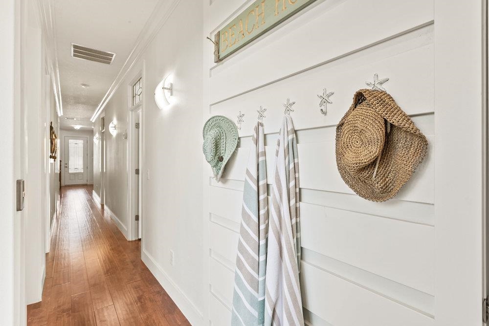 5467 Atlantic View St. Augustine, FL 32080 - Photo 13 of 42 a view of a hallway with wooden floor and a mirror