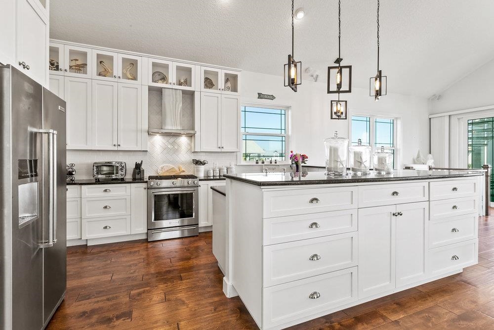5467 Atlantic View St. Augustine, FL 32080 - Photo 16 of 42 a kitchen with granite countertop white cabinets white stainless steel appliances with a sink and dishwasher