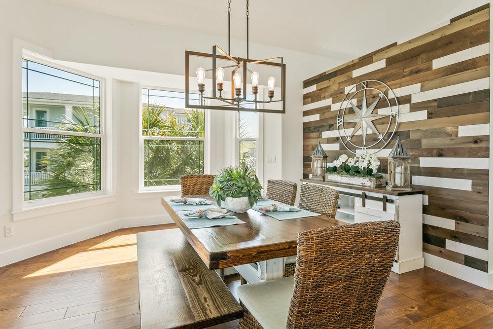 5467 Atlantic View St. Augustine, FL 32080 - Photo 21 of 42 a dining room with furniture a rug and a chandelier