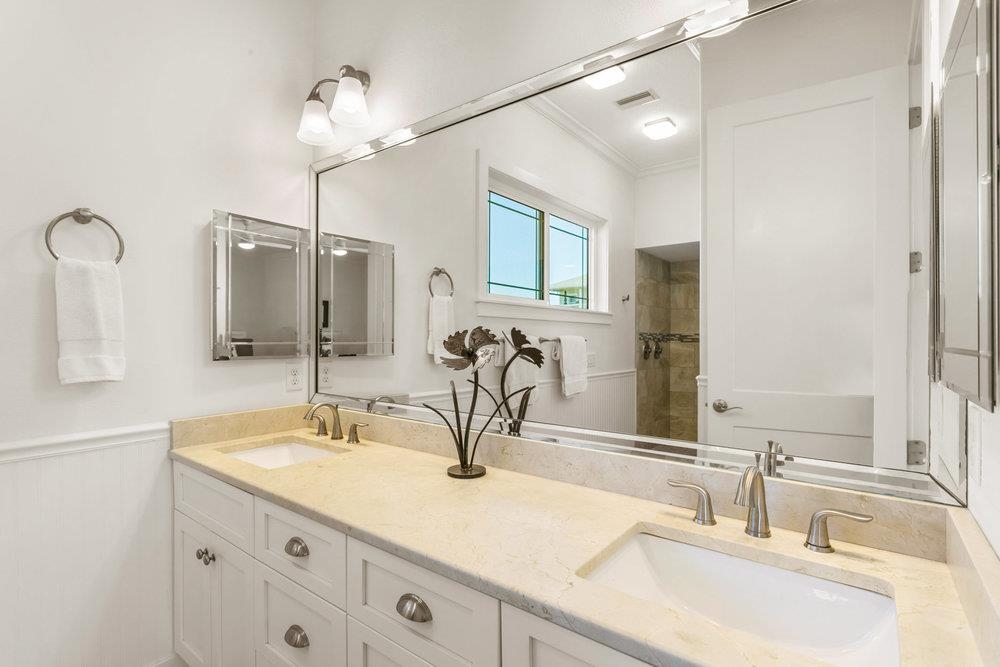 5467 Atlantic View St. Augustine, FL 32080 - Photo 30 of 42 a bathroom with double vanity sinks and a mirror