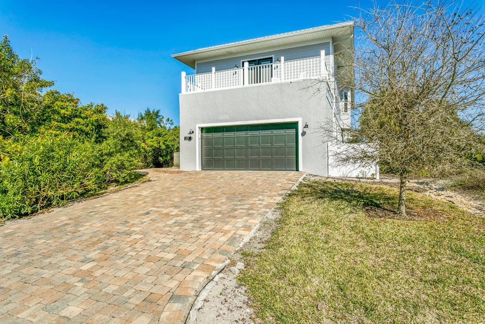 5467 Atlantic View St. Augustine, FL 32080 - Photo 36 of 42 a front view of a house with a yard and garage