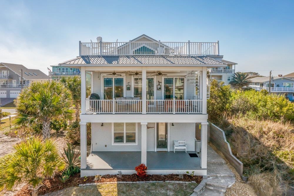 5467 Atlantic View St. Augustine, FL 32080 - Photo 37 of 42 a front view of a building with a garden and plants
