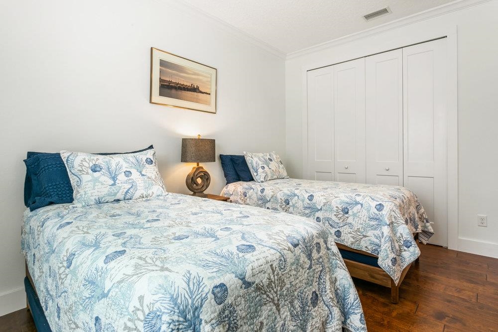 5467 Atlantic View St. Augustine, FL 32080 - Photo 8 of 42 a bedroom with a bed and wooden floor